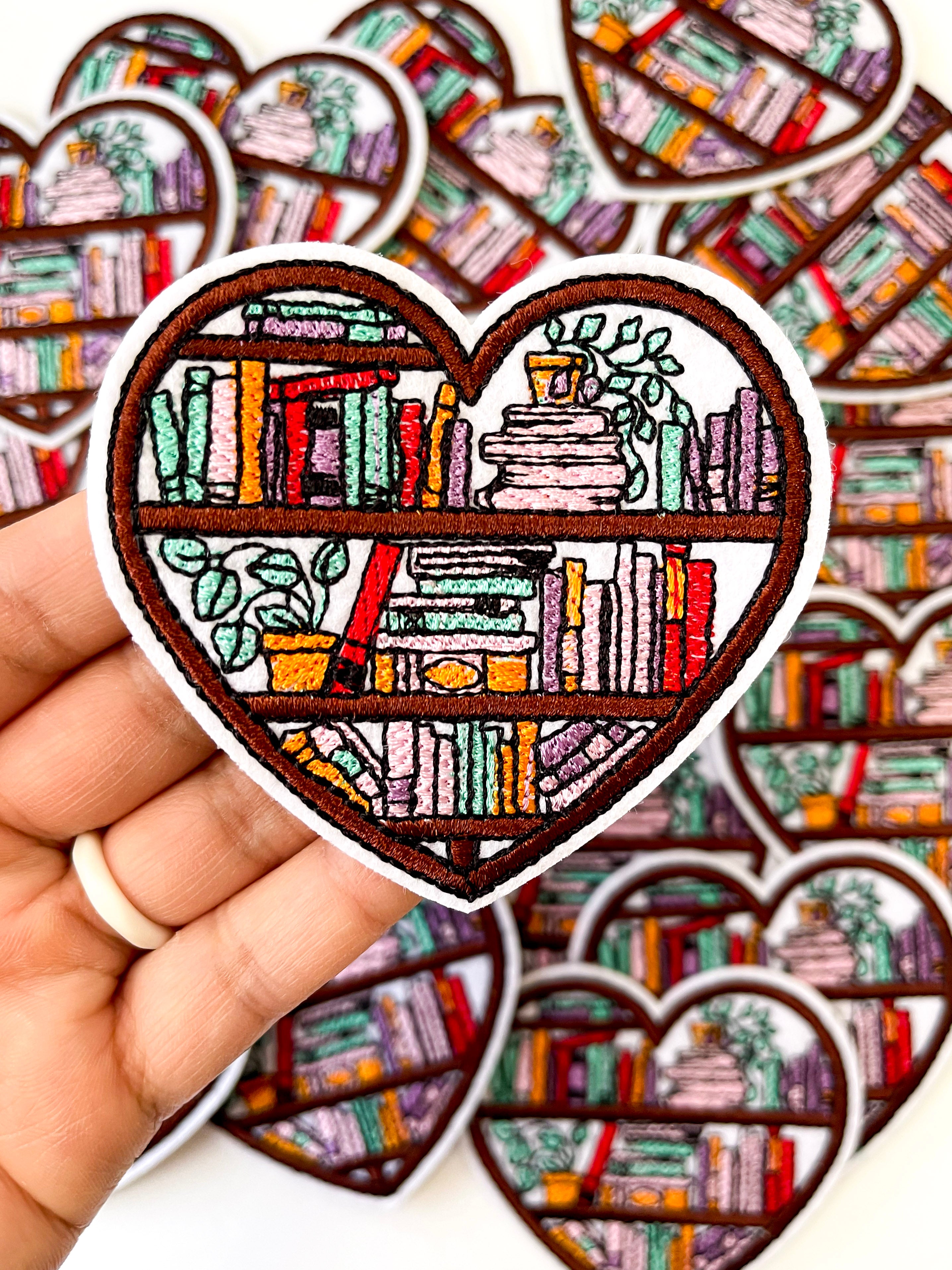 Bookish bookshelf heart iron on patch, front view, colorful book lover gift